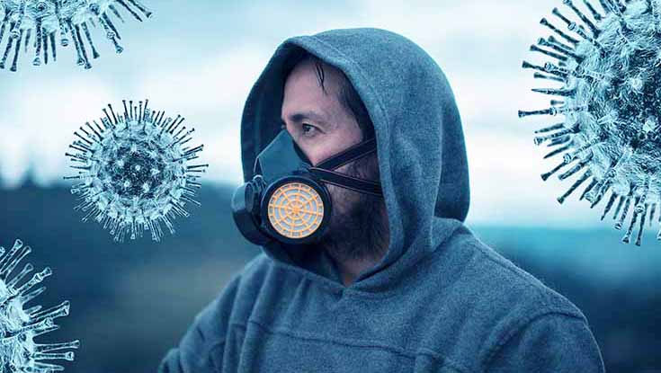 hombre con mascarilla rodeado de virus aire